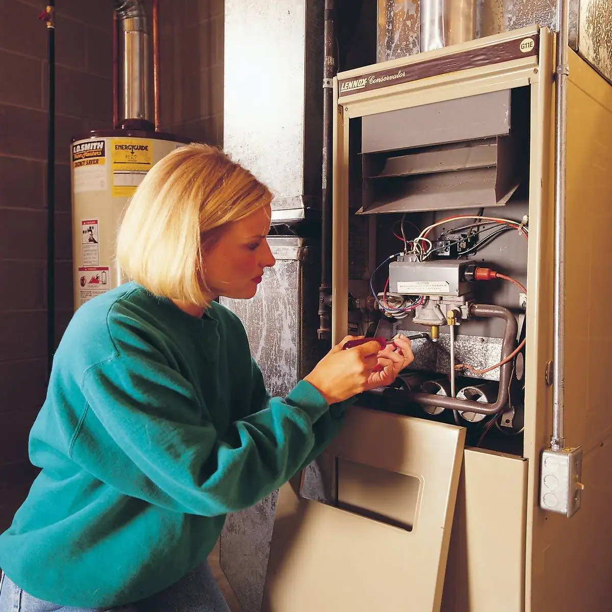 Female technician repairing furnace in Calgary, AB